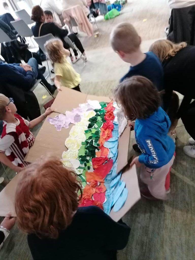 Children carrying a craft project of Joseph's coat